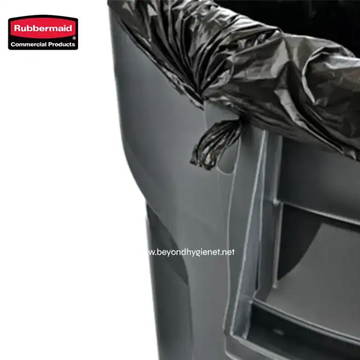 Rubbermaid trash bin with black plastic bag liner for commercial waste management.