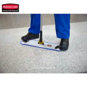 Rubbermaid commercial floor cleaning mat with mop legs, worn by person in safety boots and blue work pants, ideal for industrial and commercial hygiene management.