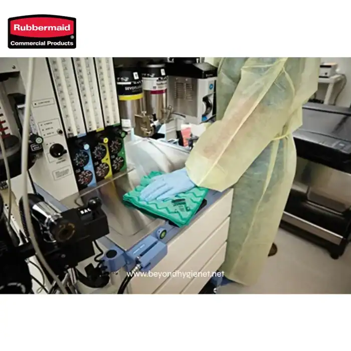 Disinfecting medical equipment in a hospital laboratory using rubber gloves and sterilization techniques.