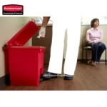 Rubbermaid commercial waste disposal bin, janitorial trash can in a professional cleaning or hospital setting.