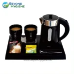 Hot beverage tea and coffee catering station with electric kettle, cups, tea bags, and creamer on black serving tray at Beyond Hygiene Asia.