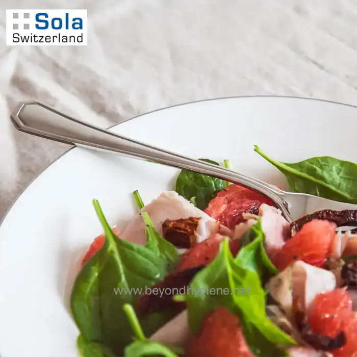 Fresh salad with spinach, strawberries, and chicken on a white plate, highlighting clean eating and healthy food options, suitable for hygiene and wellness themes at Beyond Hygiene Asia.
