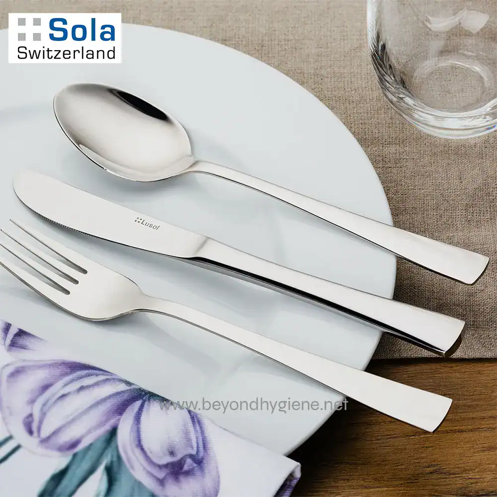 PRIMO 1810 Stainless Steel-4 Stainless steel cutlery set placed on a white plate with a glass of water, showcasing hygiene and quality dining tools from Beyond Hygiene Asia.