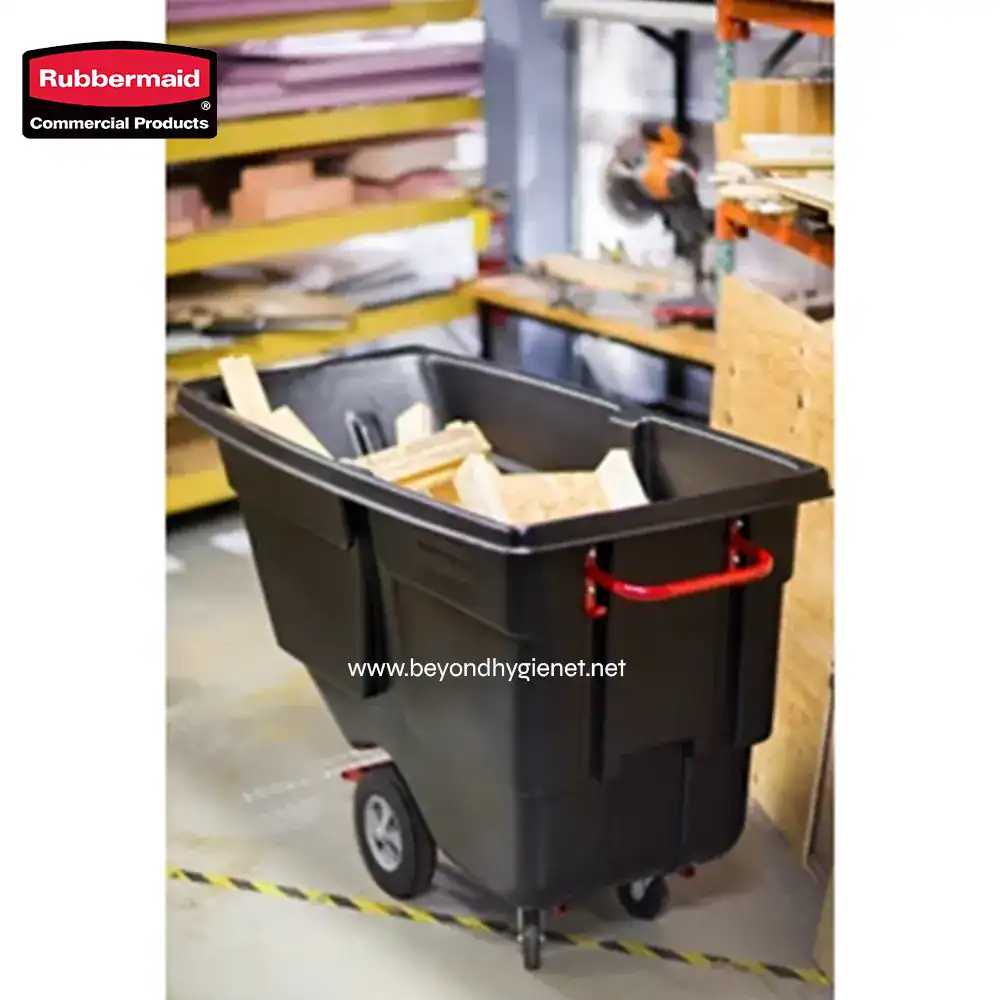 ROTOMOLDED TILT TRUCK, UTILITY DUTY, 1 CUBIC YARD, BLA ( (5) Rubbermaid industrial janitorial trash bin on wheels in a workshop setting with construction or cleaning supplies.