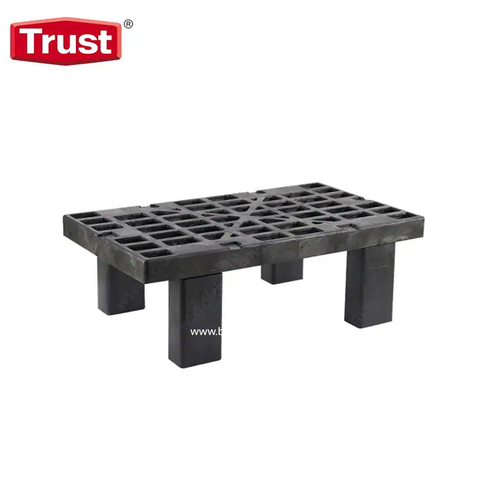 Heavy-duty black plastic pallet for industrial waste management and storage solutions.