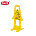 Caution wet floor warning sign, bright yellow plastic, slip hazard safety alert for commercial and public spaces.