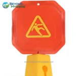 Warning wet floor slip hazard caution sign in bright yellow and red, used for safety at workplaces and public spaces to prevent accidents, emphasizing hygiene and safety standards in Asia.