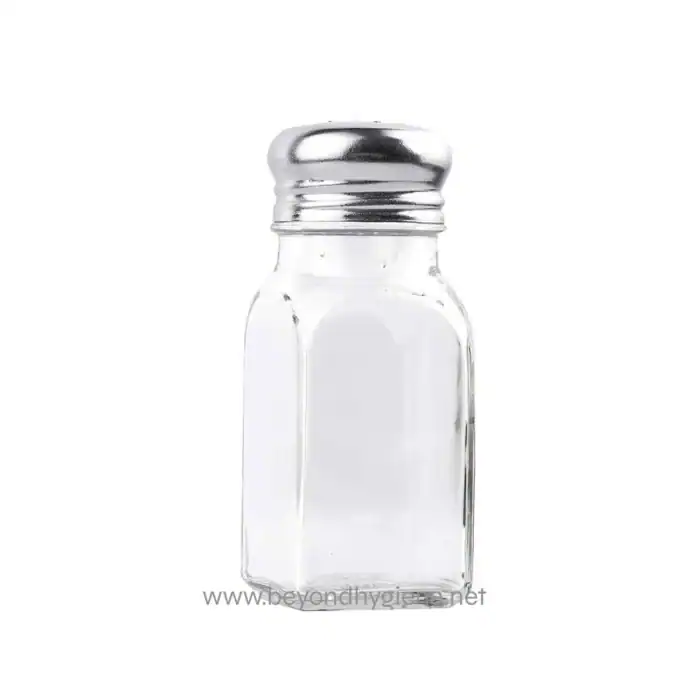Salt shaker empty clear glass container with metal lid, used for seasoning food in dining settings. Perfect for restaurants and hospitality hygiene standards.