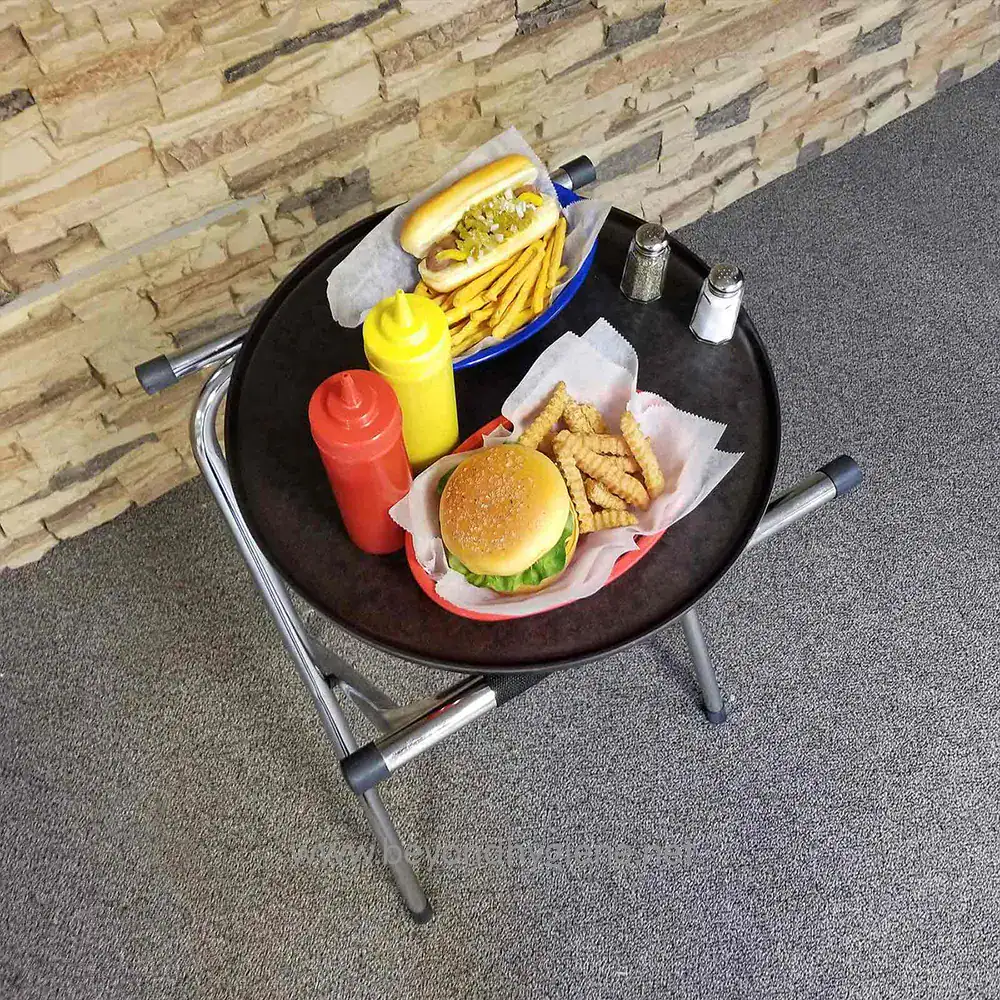 10 Hot dog with mustard and relish, French fries, cheeseburger, ketchup, mustard, salt, and pepper shakers on a black tray at Beyond Hygiene Asia.