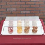 Artisan bakery display case with assorted muffins showcasing high hygiene standards and food safety; perfect for bakery and catering environments.