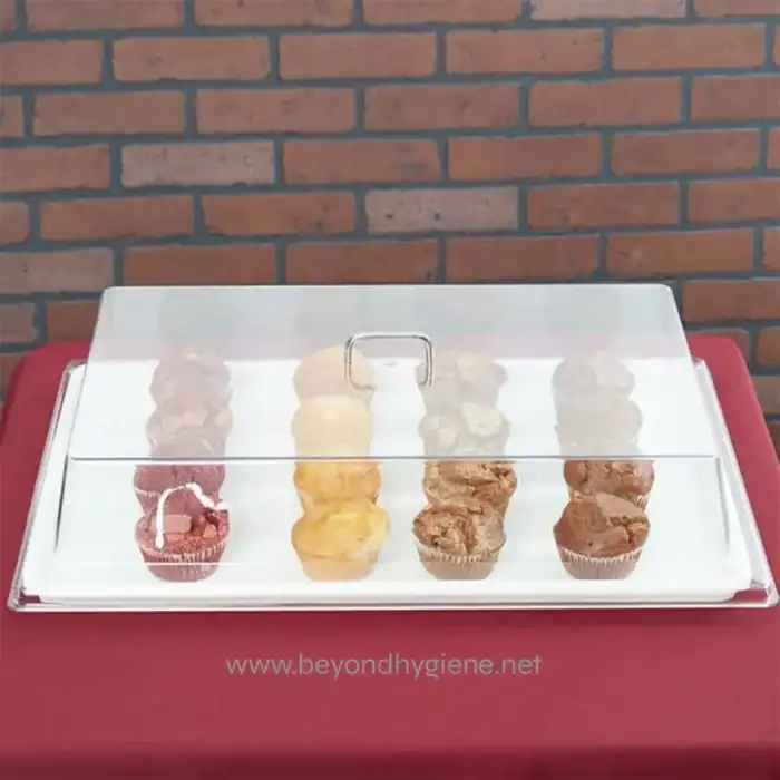 Artisan bakery display case with assorted muffins showcasing high hygiene standards and food safety; perfect for bakery and catering environments.