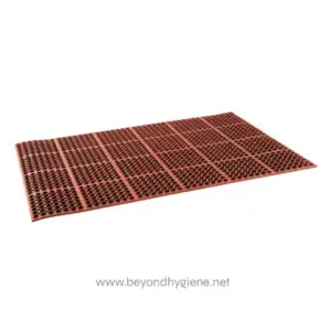 Red anti-slip rubber mat with drainage holes for industrial and commercial use, enhancing safety and hygiene in workplaces.
