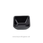 Rich black sauce in glass syrup dispenser with breakfast foods in background, emphasizing hygienic food service.