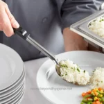 Steaming rice and vegetables serving at a catering event, commercial kitchen, or buffet setting, focused on food service hygiene and sanitation practices in Asia.