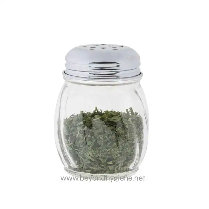 Fresh dried herbs in a glass jar with a metal shaker top, suitable for culinary and medicinal use, showcasing premium quality herbs from Beyond Hygiene Asia.