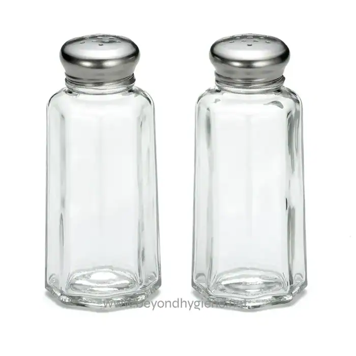 Salt and pepper shakers made of clear glass with silver caps, ideal for table settings and food service. Perfect for restaurants and households looking for durable, stylish condiment dispensers.