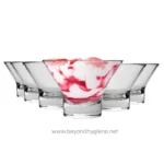 Smooth glass bowls with pink and white ice cream, empty bowls around, clean and elegant dessert presentation, beyond hygiene asia, food service, ice cream display, sanitation standards, hygiene solutions.