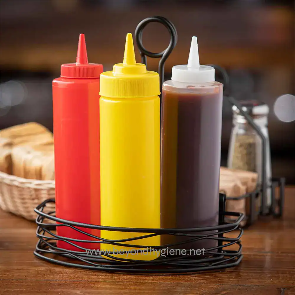 5 Ketchup mustard and barbecue sauce bottles on a wooden table in a restaurant setting.