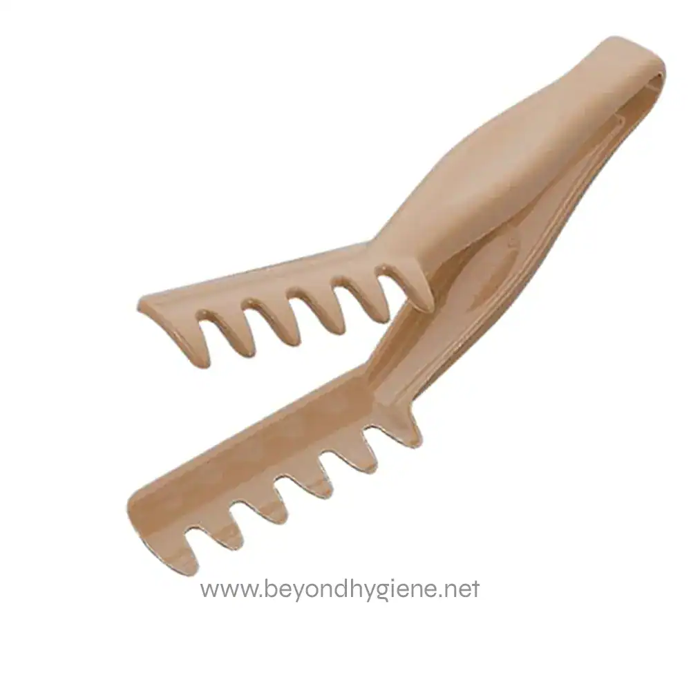 A beige plastic hairdressing sectioning clip with serrated teeth for sectioning hair during styling or cutting.