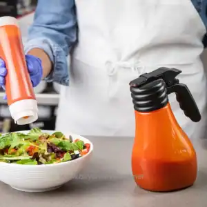 Spray bottle for food hygiene and sanitation in restaurant kitchen, preparing salads, cleaning fresh vegetables with hygienic spray.