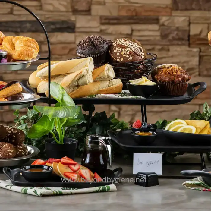 Scones and muffins on a tiered serving tray with fresh fruit and tea, perfect for breakfast or brunch at Beyond Hygiene Asia, emphasizing bakery and catering services in Asia.