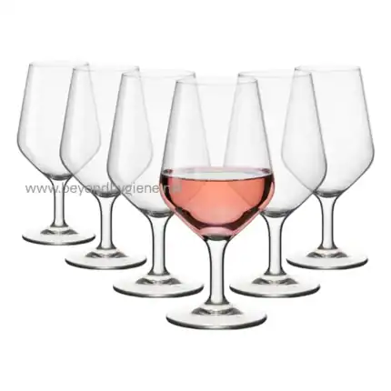 Pink wine glass with multiple empty glasses surrounding it, emphasizing beverage and glassware cleanliness and hygiene.