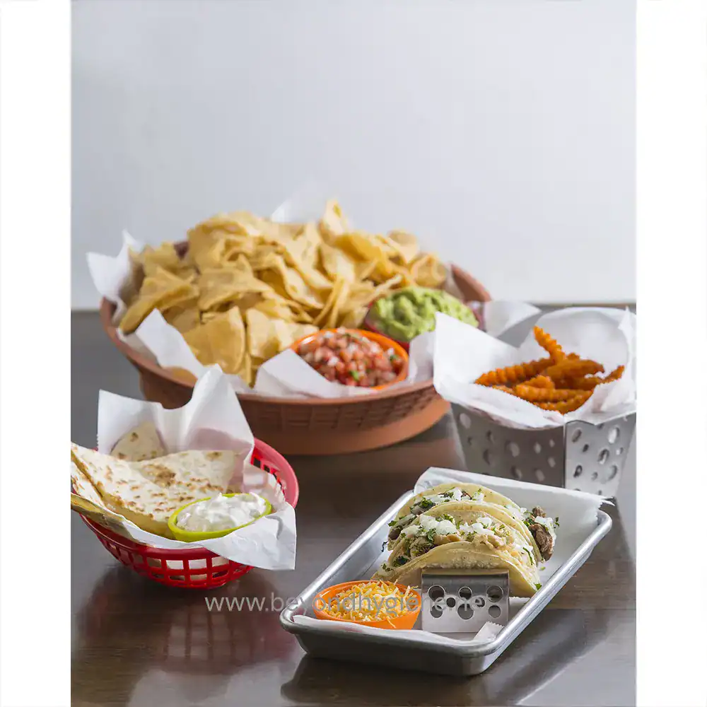 7 Crispy tortilla chips, guacamole, salsa, cheesy tacos, and French fries on a table, showcasing Mexican cuisine and food hygiene best practices at Beyond Hygiene Asia.