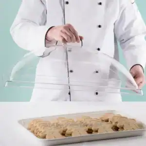 Freshly baked cookies protected under a transparent food cover, showcasing hygiene and food safety standards practiced by Beyond Hygiene Asia.