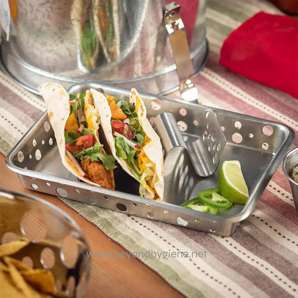 8 Freshly prepared street-style tacos with crispy fried protein, topped with colorful vegetables and herbs, served with lime wedges for added flavor, on a clean serving tray.