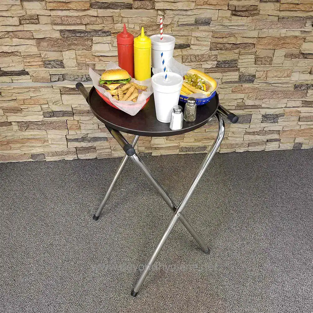8 Fresh fast-food meal on a black round tray with ketchup, mustard, salt, pepper, and drinks, set against a stone wall background in a casual dining environment.