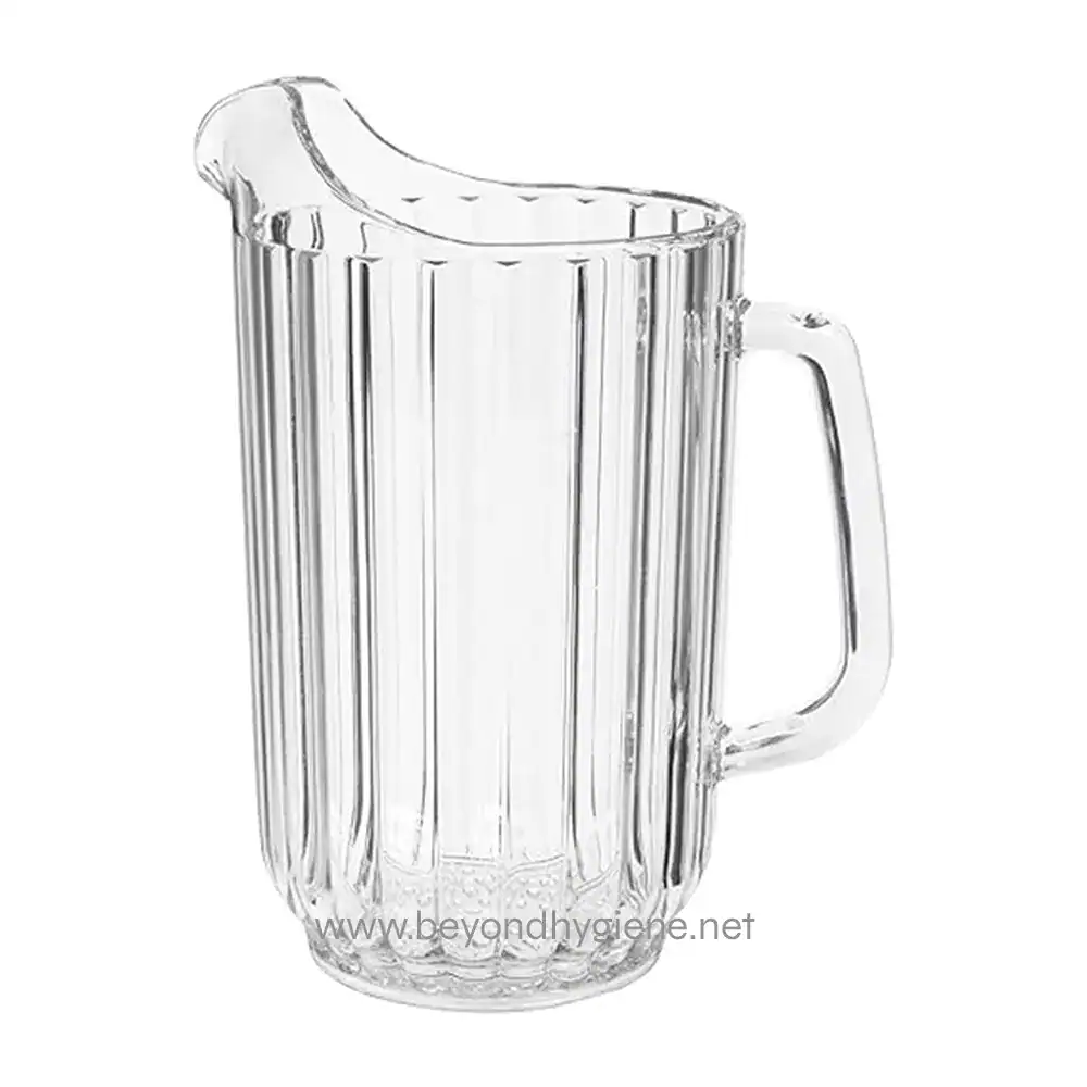 Clear glass pitcher for beverages, with a ribbed design and handle, ideal for commercial or home use in hospitality settings.