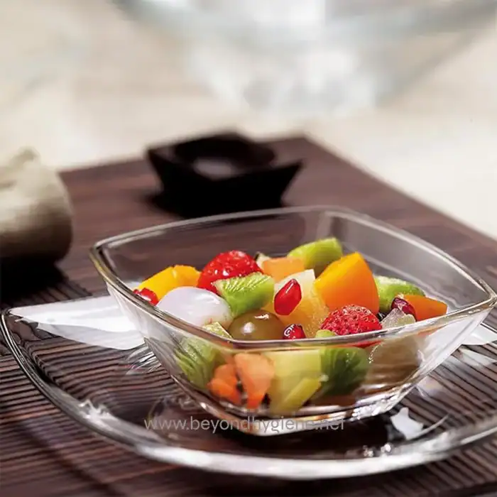 Fresh mixed fruit salad in a glass bowl, healthy snack option, vibrant colorful fruits, clean food presentation, suitable for health-conscious dining.