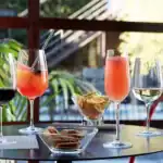 Refreshing beverages on a patio table with snacks, showcasing hygiene and cleanliness in Asia. Perfect for social gatherings, emphasizing hygiene standards at Beyond Hygiene Asia.
