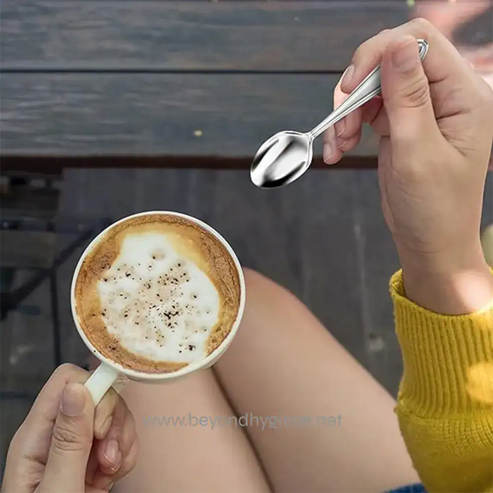 91pncSemfJL._AC_SX569_ Coffee cup with foam and a spoon in hand on wooden table, cozy morning beverage, hot coffee served in a mug, beverage with frothy top, casual coffee time scene.