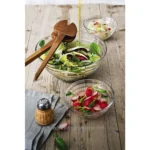 Fresh mixed salads with radishes and cucumbers in glass bowls on rustic wooden table, emphasizing healthy eating and culinary hygiene, suitable for Beyond Hygiene Asia SEO focus.