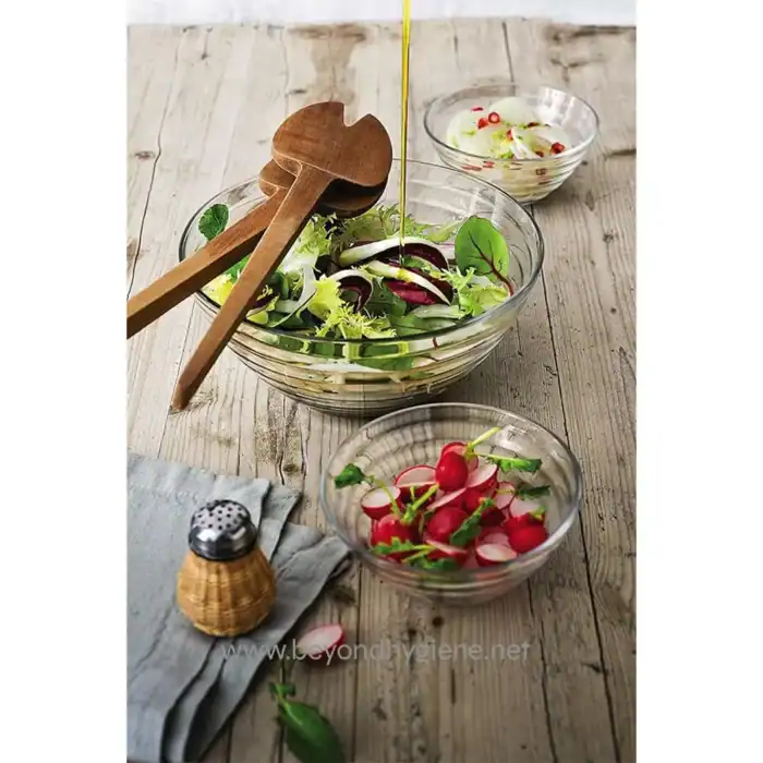 Fresh mixed salads with radishes and cucumbers in glass bowls on rustic wooden table, emphasizing healthy eating and culinary hygiene, suitable for Beyond Hygiene Asia SEO focus.