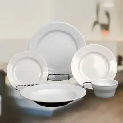 Elegant white ceramic dinnerware set including plates and bowls, perfect for everyday meals and special occasions.