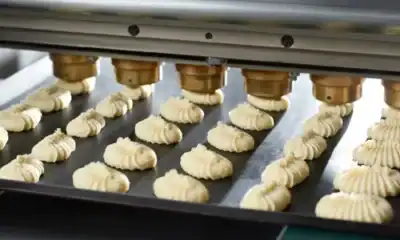 Extrusion machine producing baked pastry products at Beyond Hygiene Asia bakery, food manufacturing, industrial bakery equipment, food safety.