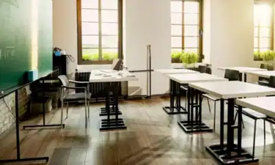 Modern classroom with desks, chairs, and large windows providing natural light, ideal for educational settings focusing on hygiene education and sanitation practices in Asia.