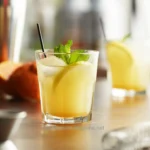 Lemonade with mint garnished in a clear glass, fresh and refreshing beverage.