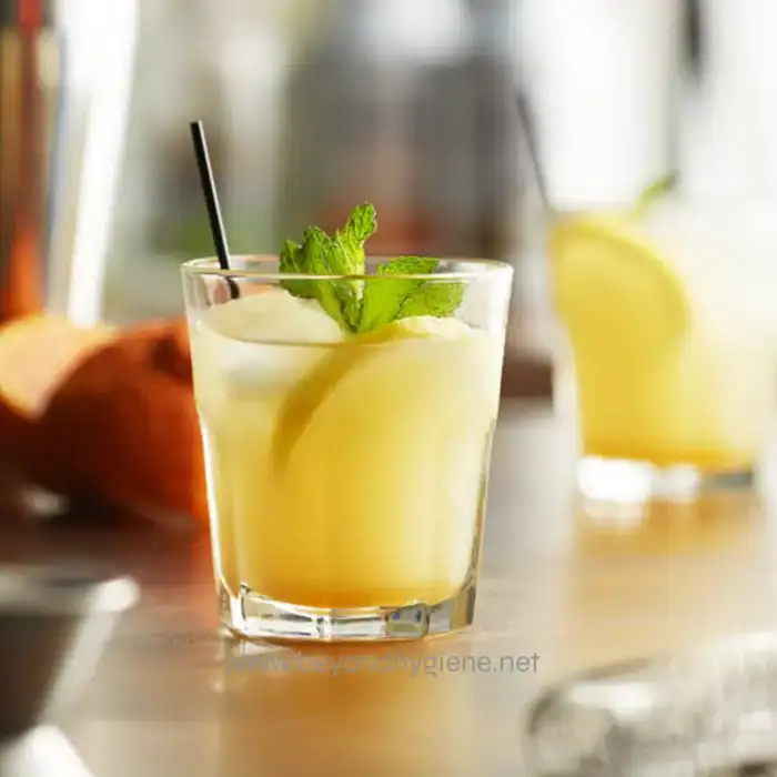 Lemonade with mint garnished in a clear glass, fresh and refreshing beverage.