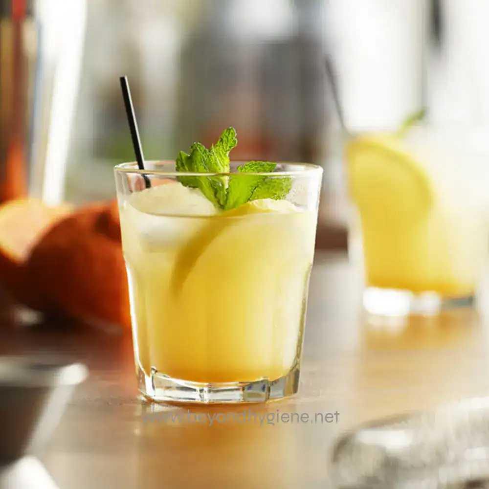 Lemonade with mint garnished in a clear glass, fresh and refreshing beverage.