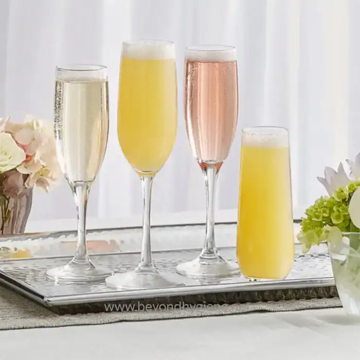 Elegant champagne glasses filled with sparkling beverages for celebrations, symbolizing hygiene and cleanliness in event settings.
