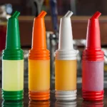 Green and yellow squeeze bottles with flip-top caps used for condiments at a restaurant or cafe, colorful food condiment containers, restaurant and catering supplies, food presentation tools, Beyond Hygiene Asia.