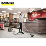 Vacuuming the flooring in a retail store with professional cleaning equipment for hygiene and cleanliness.