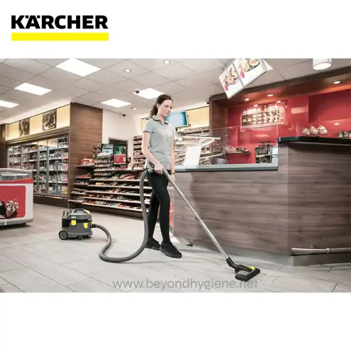 Vacuuming the flooring in a retail store with professional cleaning equipment for hygiene and cleanliness.