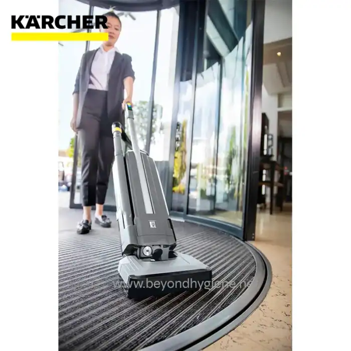 Kärcher cordless commercial carpet cleaner being operated by staff at the entrance of Beyond Hygiene Asia, demonstrating professional cleaning solutions for hospitality and commercial spaces.