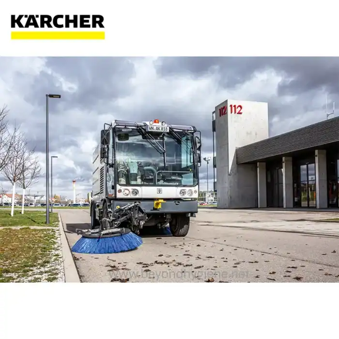 Kärcher street cleaning vehicle equipped with a large rotating brush for efficient outdoor sanitation and cleanliness services. Perfect for municipalities and commercial cleaning projects.