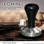 Stainless steel coffee tamper with black handle, used for professional espresso coffee machines, on wooden surface with coffee beans and burlap sack, highlighting quality coffee equipment from Beyond Hygiene Asia.