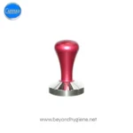 Carimali red espresso tamper for coffee machines, essential barista accessory for consistent coffee brewing, available at Beyond Hygiene Asia.